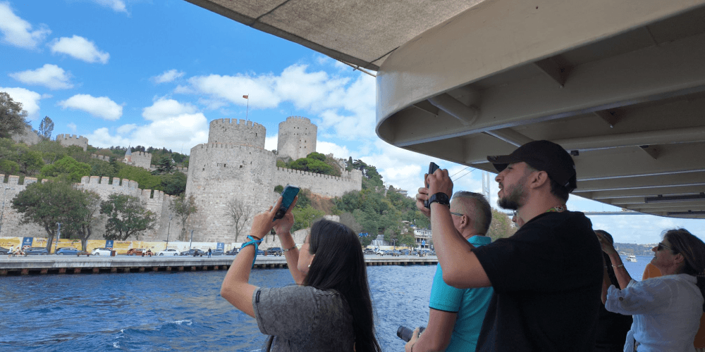 Tour boat cruising along the Bosphorus with live guide explaining landmarks in Istanbul