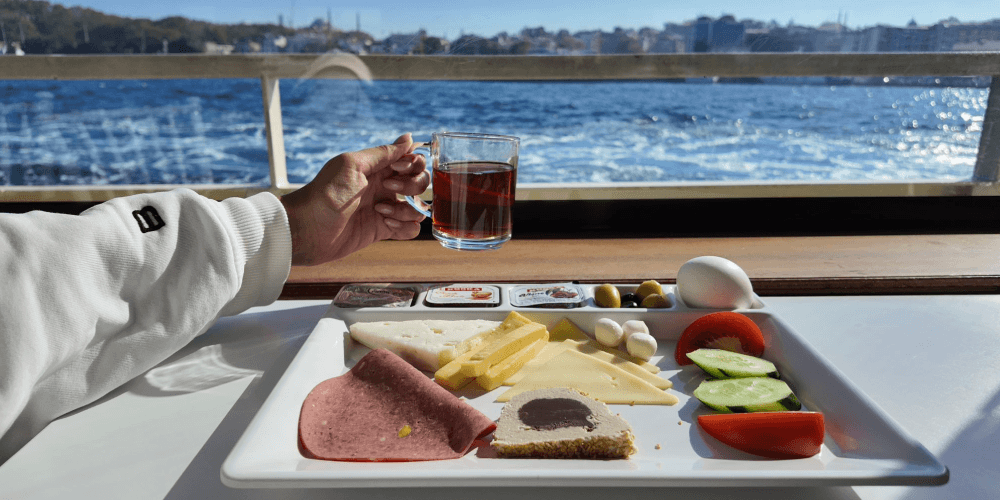 Tourists enjoying open deck views on Istanbul Bosphorus sightseeing cruise