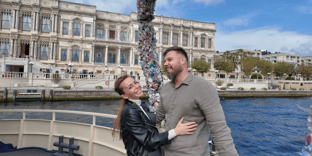 Travelers taking photos of Istanbul landmarks during Bosphorus boat tour