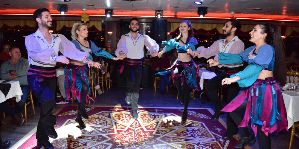 Guests watching Turkish folk dance performance on New Year’s Eve dinner cruise in Istanbul