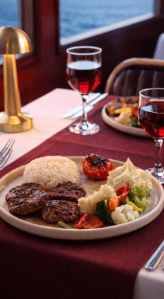 Elegant dinner table with food service on Bosphorus night cruise