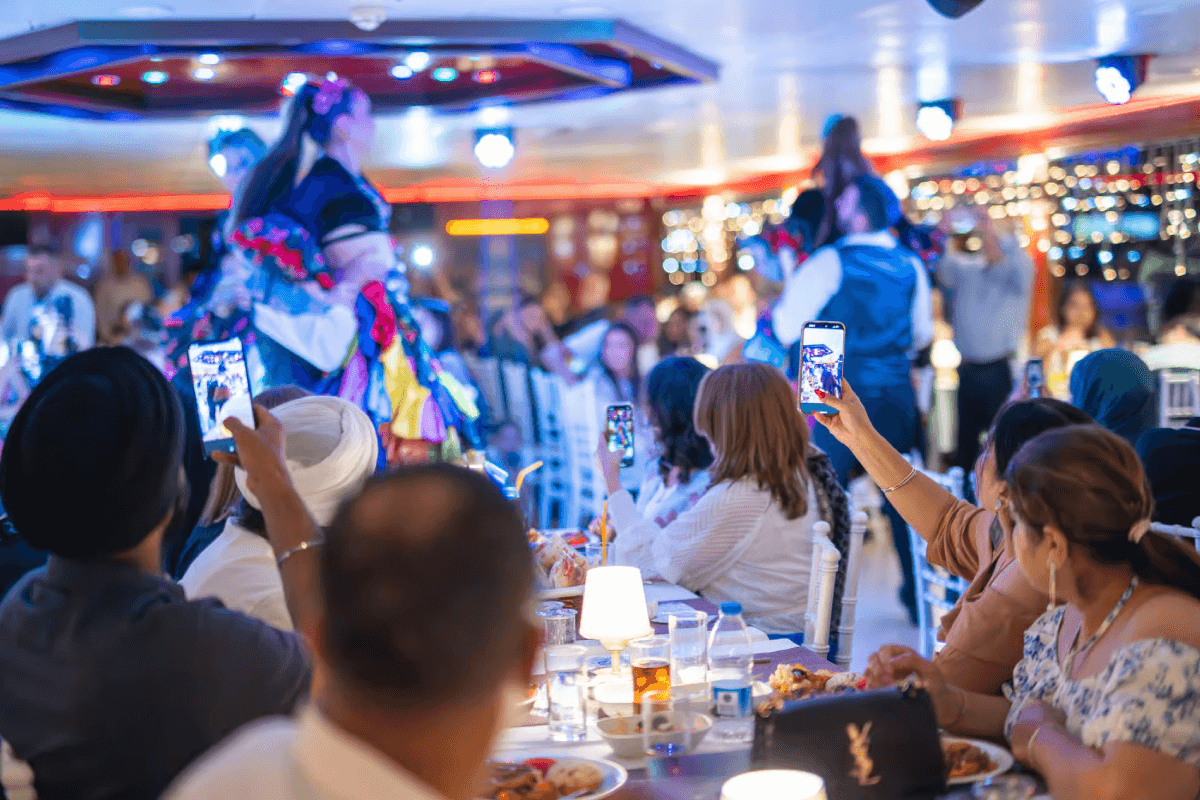 Happy tourists celebrating on a Bosphorus dinner cruise Turkish night